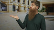 © Krakenimages.com - Young caucasian man with beard presenting open palm and tilted head on city street; skepticism doubt inquiry.