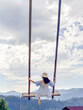 © phpetrunina14 - Woman Swinging Over Scenic Carpathian Mountain Landscape