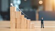 © liam turner - Wooden block staircase with business figurine and upward arrow, symbolizing growth, success, and career advancement in professional development design.
