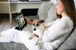 © Westend61 - Interior designer examining floor plan on tablet PC and sitting with dog at home