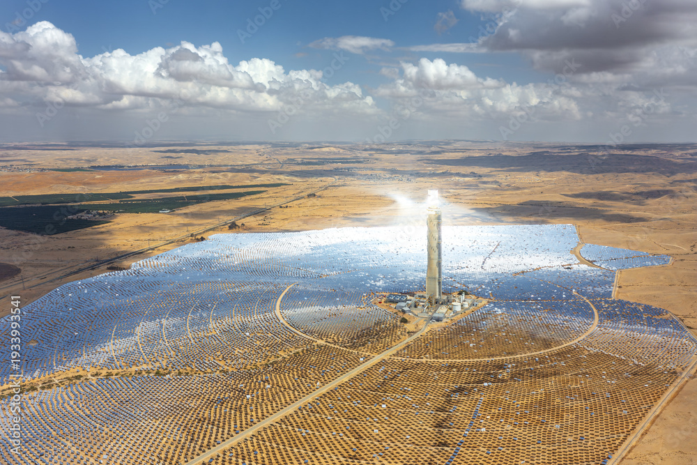 Stock-Foto „Aerial view of a solar power station with a towering ...