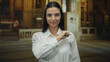 © Krakenimages.com - Woman in white shirt extends fist to camera in church setting with peruvian flag in background showcasing confidence and empowerment in religious environment indoors hispanic young.