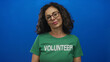 © Krakenimages.com - Middle age hispanic woman volunteer in green shirt sticks out tongue in studio; cheekiness fun happiness joy.