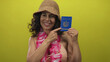 © Krakenimages.com - Woman wearing a pink lei and bikini holds a cuban passport against a vibrant yellow background, embodying travel excitement.