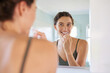 © Rido - Happy woman brushing teeth during morning routine