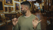 © Krakenimages.com - Young hispanic man expressing fear or disapproval in an art gallery, surrounded by ornate paintings and luxurious furniture, highlighting his emotional reaction indoors.