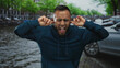 © Krakenimages.com - Man plugs ears with fingers on street by amsterdam canal, grimacing and mouth open as if shouting at traffic; frustration overload.