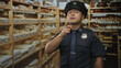 © Krakenimages.com - Man in police uniform points finger at camera amid rows of labeled wooden storage packages in building aisle; vigilance duty.