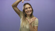 © Krakenimages.com - Woman smiling against a purple background, hands framing face, expressing joy and positivity.
