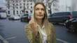 © Krakenimages.com - Woman standing on a city street with cars in the background, conveying urban life and daily routine outdoors.