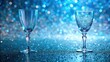 © chokdeelaw - Iridescent glassware resting on a bed of shimmering light blue glitter background