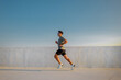 © muse studio - Runner practices on rooftop during sunset, enjoying outdoor workout for fitness and health