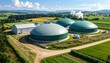 © Pipi - Aerial view of a biogas plant with green domes in a rural landscape