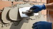 © Sumados - Plasterer smoothly applying cement mortar on brick wall with a metal trowel