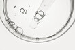 © colnihko - Pipette dropping clear liquid into glass petri dish, creating small bubbles