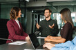 © Stock 4 You - Young male team leader ceo businessman having strategy planning discussion collaboration with employees sitting at office workplace desk. Group of professional business people discussing work project