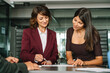 © Stock 4 You - Female workers doing teamwork at meeting in office. Mature business woman investor financial sale invoice enterprise law document, discussing with consult colleague marketing project looking on paper