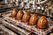 © Denisz - Automated production line filling chocolate Easter eggs with molten chocolate in a factory