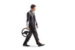 © Ljupco Smokovski - Pensive man in a torn suit walking and holding a steering wheel