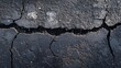 © Ira - Cracked asphalt surface showing signs of wear and weathered texture