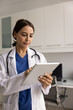 © fizkes - Middle-Eastern woman therapist working online using digital tablet device, check lab results, scans or imaging, prescribe medications electronically, conduct telemedicine session with patients via app