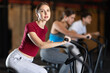 © JackF - Woman in sportswear trains on an airbike in a gym. European woman at cardio workout in the Crossfit gym