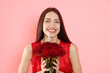 © New Africa - Woman with bouquet of roses on pink background