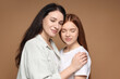 © New Africa - Mother and her teenage daughter on beige background