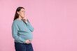© New Africa - Choosing name for baby. Thoughtful pregnant woman on pink background, space for text