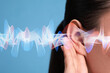 © New Africa - Hearing health. Woman with audio waves near her ear on blue background, closeup