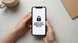 © ViskBx - Hands holding a smartphone displaying a security alert for unusual activity detected, symbolizing cyber protection and data privacy