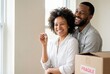© Meow Creations - Joyful african american couple with house key in new home