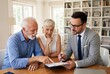 © Meow Creations - Senior couple consulting with professional financial advisor about retirement plans and documents