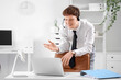 © Pixel-Shot - Young businessman working with headset and laptop on desk in office