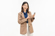 © sitthiphong - Smiling young Asian businesswoman using smartphone and pointing at mobile screen on white studio background.