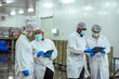© Wanwajee - Manufacturing managers perform facility walkthrough and verify sanitation protocol in high volume processing plant. Concept emphasizes food safety governance and audit preparation process.
