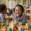 © VictorCanalesStudio - Joyful child laughing while building structures with colorful wooden blocks in preschool