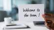 © Tetyana - Human resources department welcoming new employee to corporate team, offering warm greeting card, celebrating successful hiring and onboarding process in office workplace