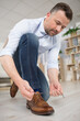 © auremar - a man fastening shoe laces