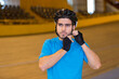 © auremar - young cyclist putting on his helmet inside velodrome
