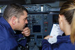 © auremar - male and female engineers in aircraft cockpit