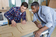 © auremar - two carpenters working on the wood in workshop