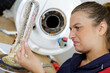 © auremar - female plumber finding rust inside boiler