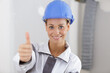 © auremar - cheerful female architect and construction engineer giving a thumbs up