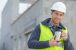 © auremar - cheerful architect in helmet with cup of coffee