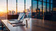 © Jonathan - Laptop with financial charts open on a wooden table during sunset in a modern office boardroom.