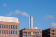 © yaqui_villegas - Brick architecture of industrial factory building with smokestack on Hamburg Germany skyline against bright sky in daylight