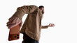 © master1305 - Man holding smartphone behind back from low perspective isolated on white. Concept of hidden message, secret communication, online privacy, digital security and confidential mobile interaction.