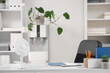 © Pixel-Shot - Electric fan on desk in office