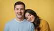 © Vasiliy - Joyful young couple with man laughing and woman leaning on his shoulder. Bright yellow studio background. Happiness and comfort in relationship concept